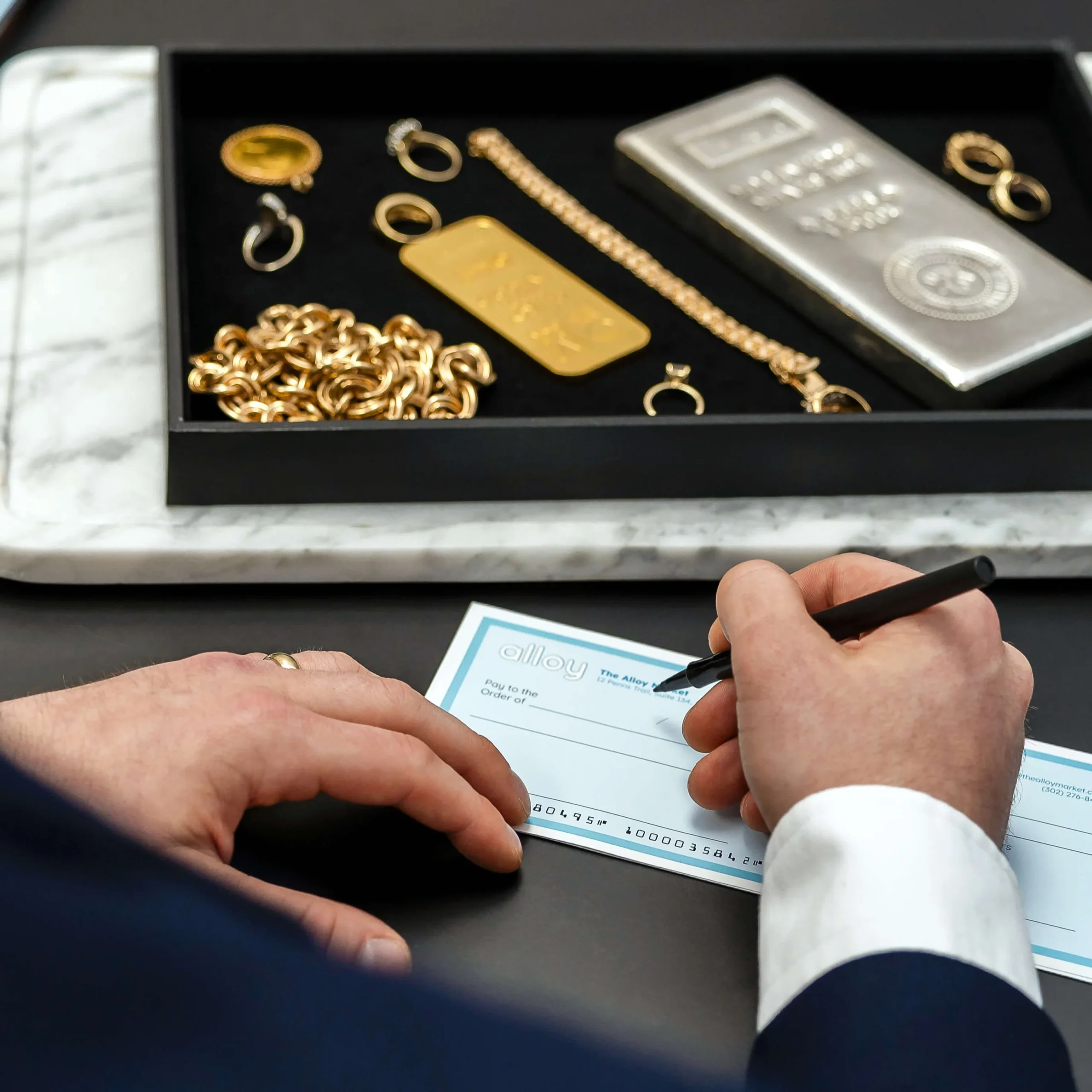 Alloy paying customer for selling gold